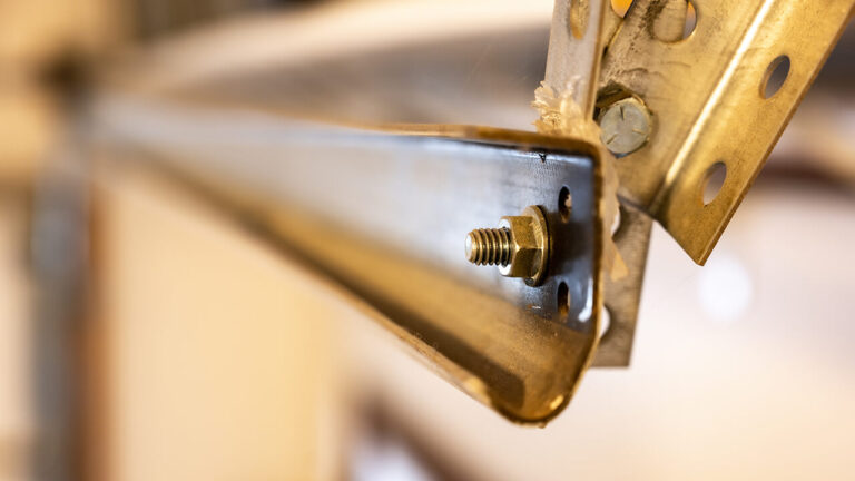 How to adjust garage door springs and cables